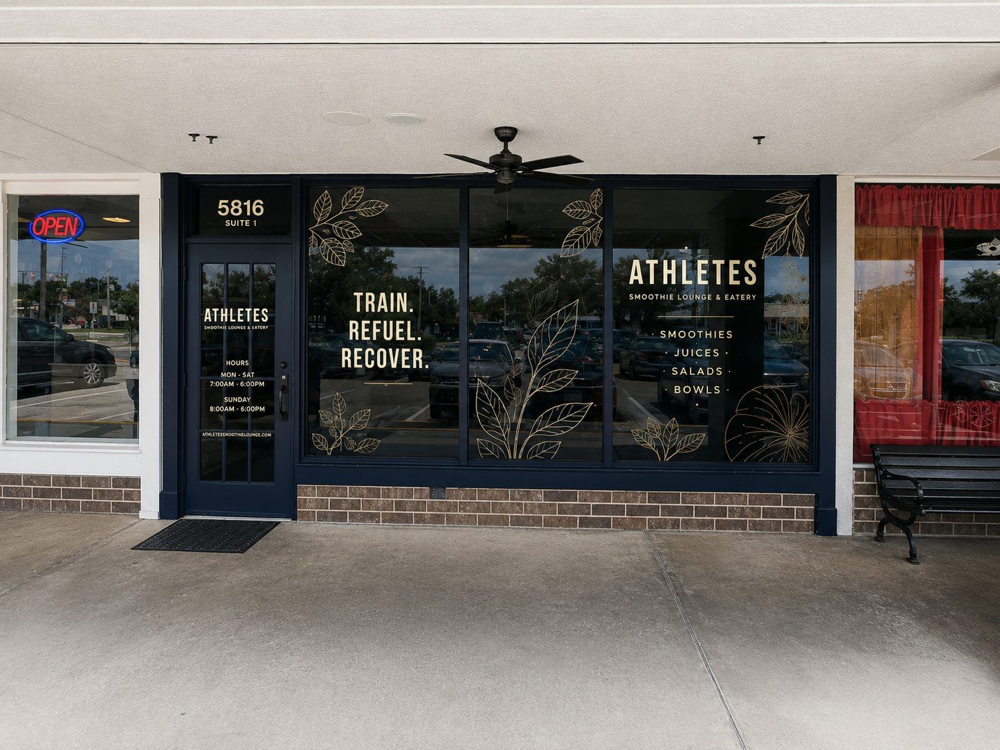 The ATHLETES entrance — 5816 Suite 1, navy storefront with gold leaf window graphics reading Train. Refuel. Recover.
